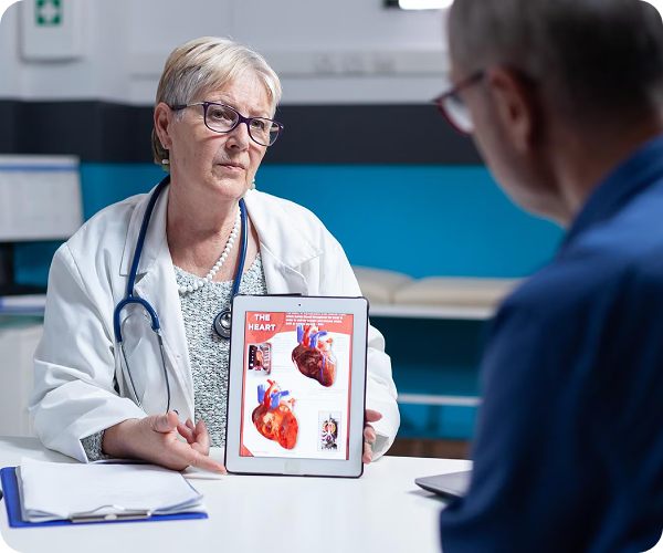 Cardiologist explaining heart anatomy to a patient during a consultation